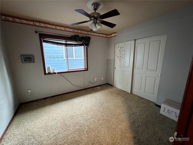 unfurnished bedroom with a closet, ceiling fan, and carpet