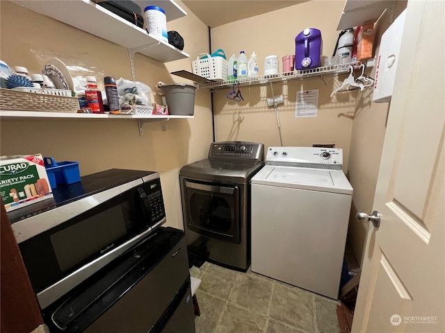 clothes washing area with separate washer and dryer