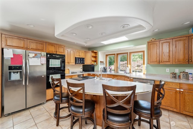 13629 Rector Rd, Bow, WA 98232 - kitchen featuring black appliances, light tile patterned floors, a raised ceiling, a sink, and recessed lighting