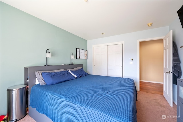 bedroom featuring a closet and light colored carpet