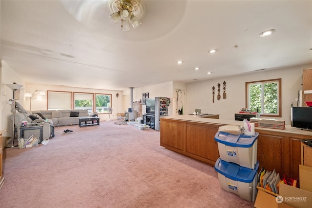 interior space featuring light carpet and ceiling fan