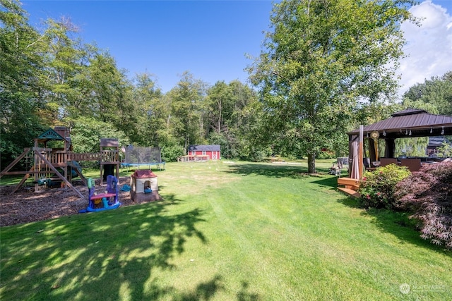 view of yard featuring a gazebo, a shed, and a playground