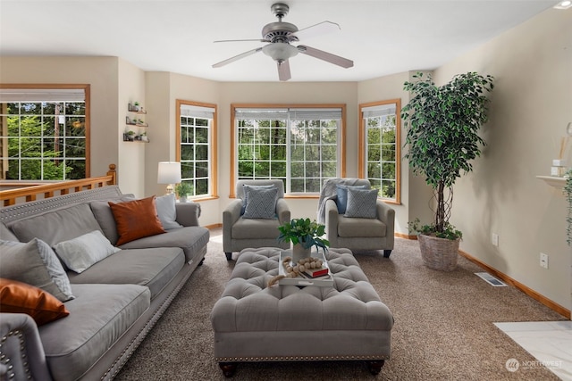 carpeted living room featuring ceiling fan and plenty of natural light