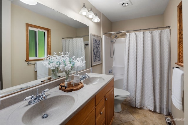 full bathroom featuring vanity, toilet, tile patterned floors, and shower / tub combo with curtain