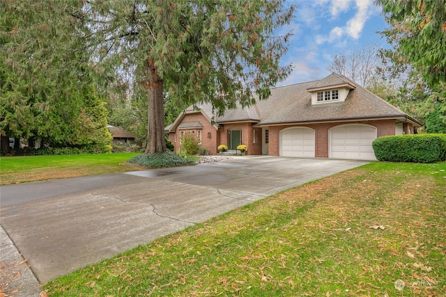 view of front of home featuring brick siding, roof with shingles, a garage, driveway, and a front lawn