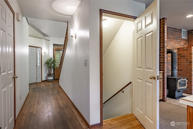 hallway with stairway, wood finished floors, an upstairs landing, and baseboards