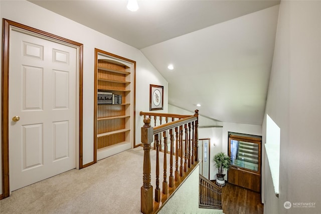 interior space with built in features, carpet, recessed lighting, baseboards, and lofted ceiling