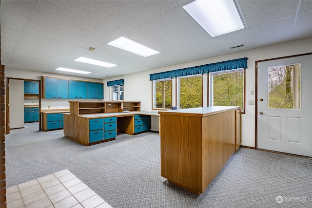 office featuring visible vents, plenty of natural light, a paneled ceiling, and light colored carpet