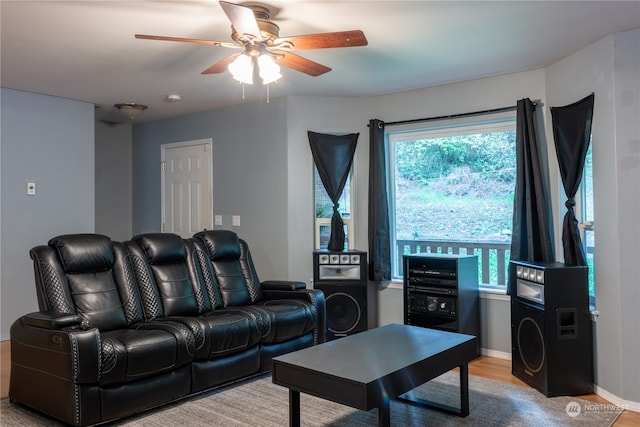 living room featuring light hardwood / wood-style flooring and ceiling fan