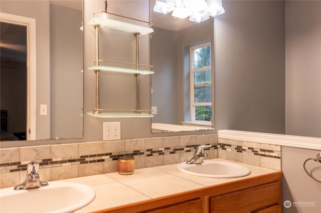 bathroom with vanity and tasteful backsplash