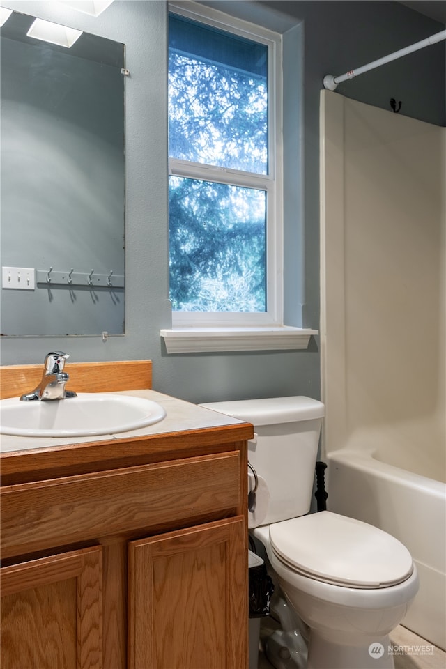 full bathroom with vanity, bathing tub / shower combination, and toilet