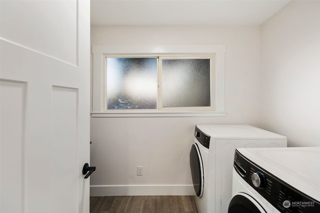 laundry room with dark hardwood / wood-style flooring and washing machine and dryer