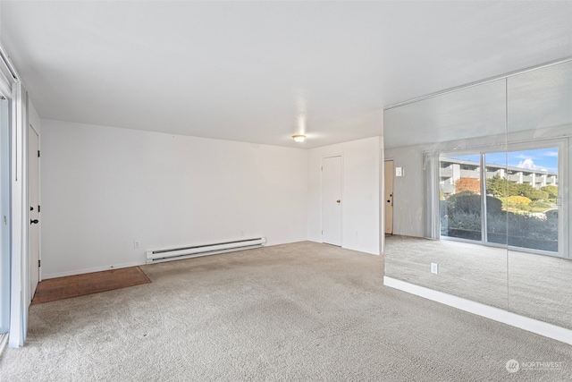 unfurnished room featuring a baseboard radiator and carpet flooring