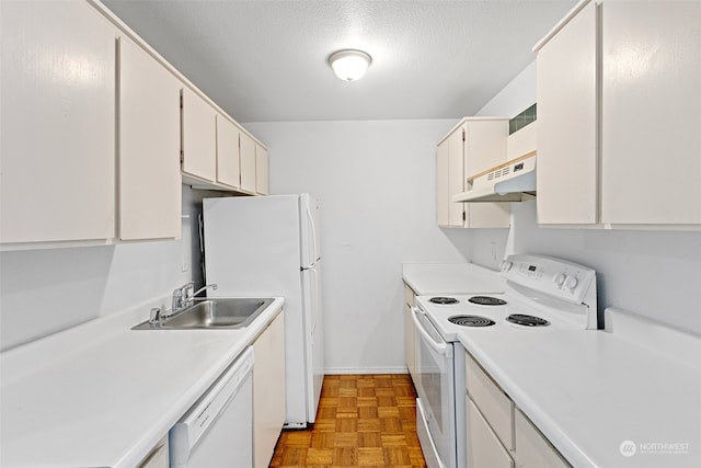 kitchen with light parquet flooring, sink, white cabinets, and white appliances