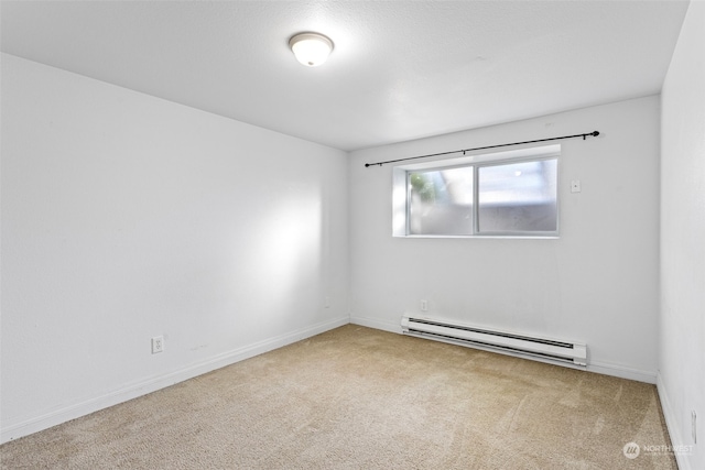 carpeted spare room featuring baseboard heating