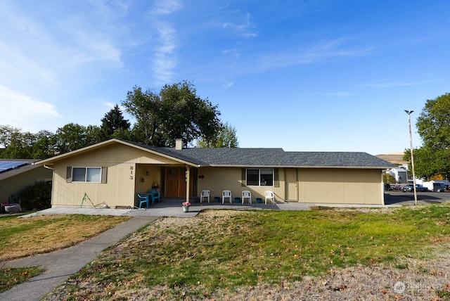 ranch-style home featuring a patio and a front yard