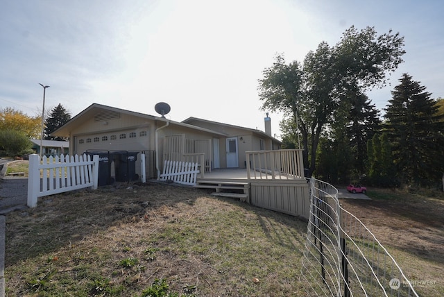 view of front of home featuring a wooden deck and a garage