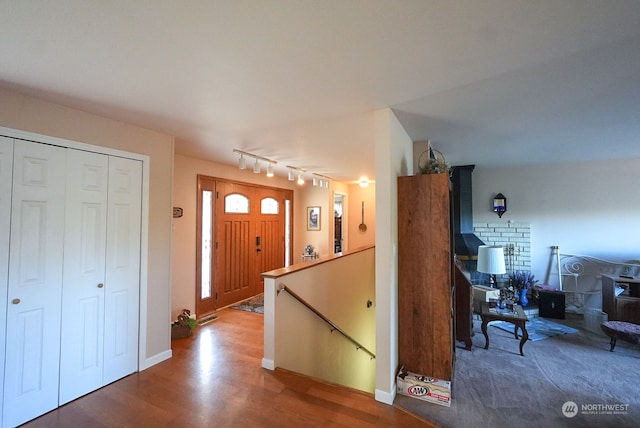 entrance foyer with wood-type flooring and track lighting