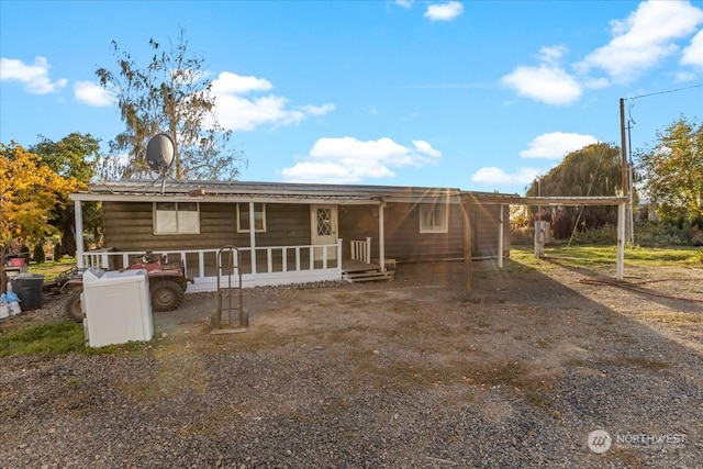 view of front of house with covered porch and a carport