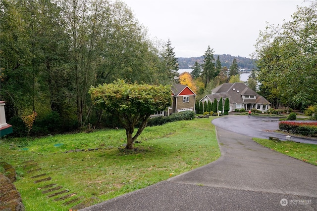 exterior space with a front yard and a water view