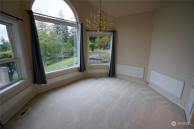 unfurnished dining area with light carpet and a notable chandelier