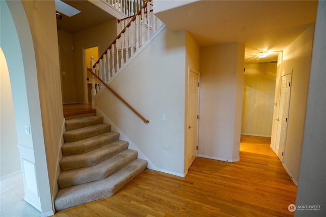 staircase featuring hardwood / wood-style floors