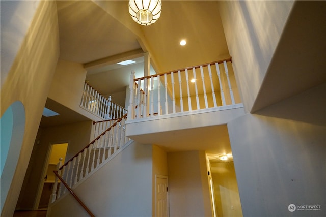 staircase featuring a towering ceiling