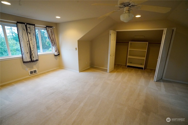 bonus room with ceiling fan, vaulted ceiling, and light colored carpet