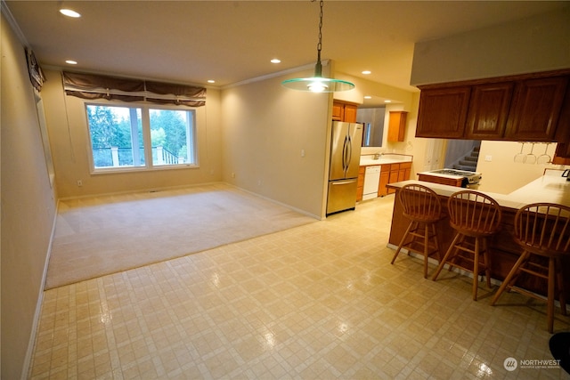 kitchen with a kitchen bar, white dishwasher, kitchen peninsula, stainless steel fridge, and light colored carpet