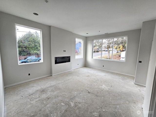 unfurnished living room featuring a wealth of natural light