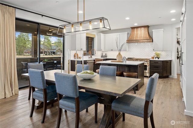 dining area featuring light hardwood / wood-style floors and sink