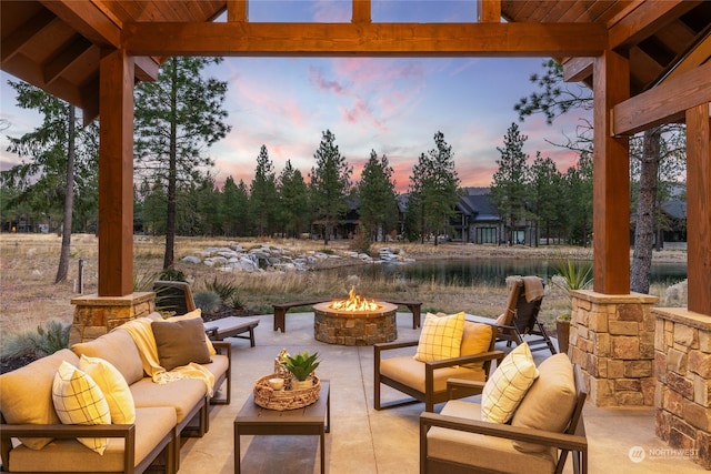 patio terrace at dusk featuring an outdoor living space with a fire pit