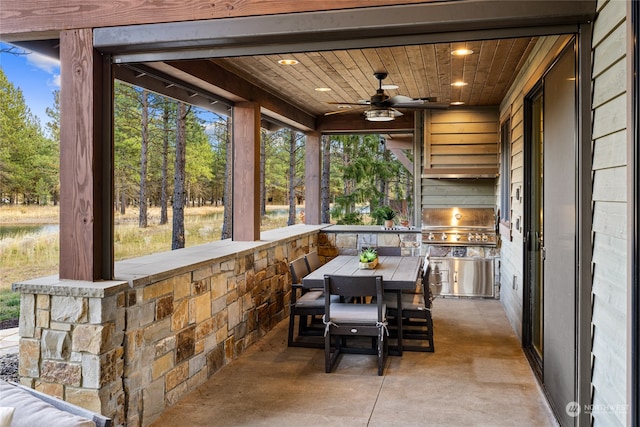 view of patio / terrace featuring a grill, ceiling fan, and an outdoor kitchen