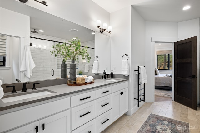 bathroom with vanity and a shower with door