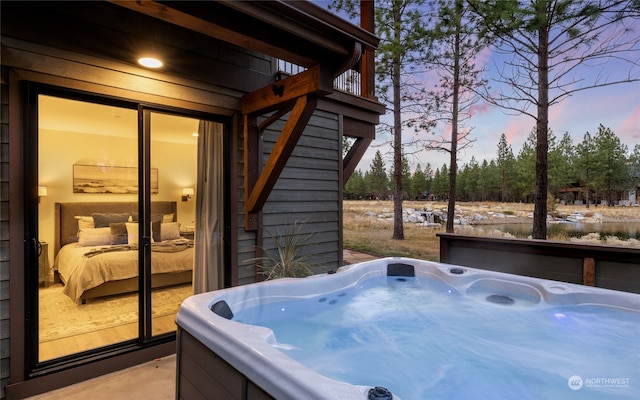 patio terrace at dusk with a hot tub