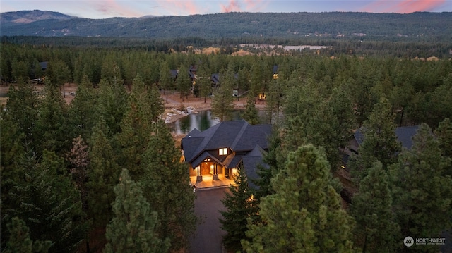 aerial view at dusk featuring a mountain view