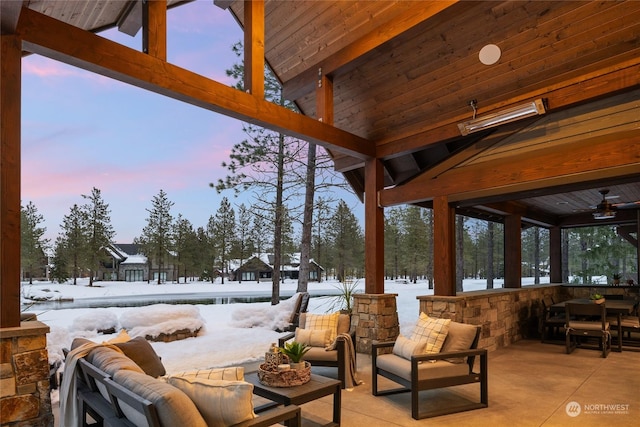 snow covered patio with an outdoor living space