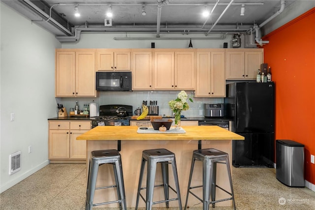 744 Market St Unit 302, Tacoma, WA 98402 - kitchen featuring black appliances, butcher block counters, light brown cabinets, and visible vents