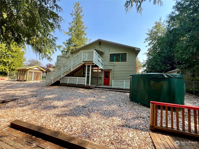 rear view of house featuring a deck