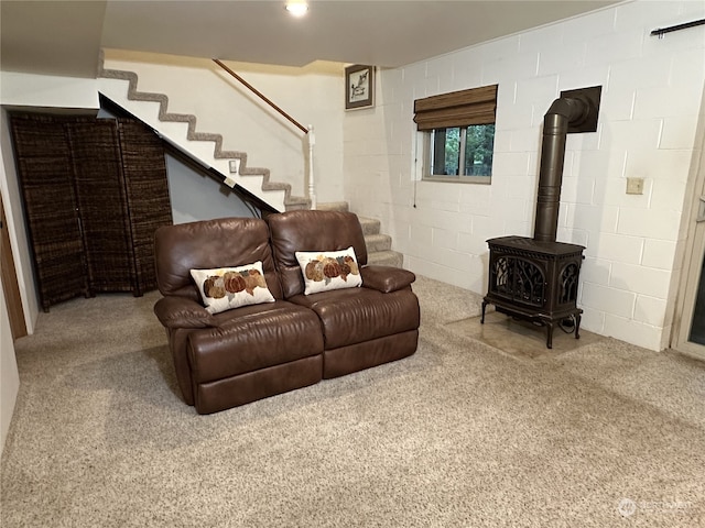 living room with carpet flooring and a wood stove