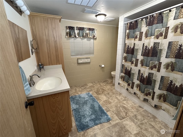 bathroom with tile walls, vanity, a shower with shower curtain, and toilet