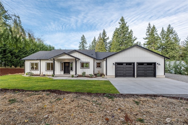 modern farmhouse featuring a garage and a front lawn