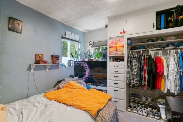 carpeted bedroom featuring a closet and a textured ceiling