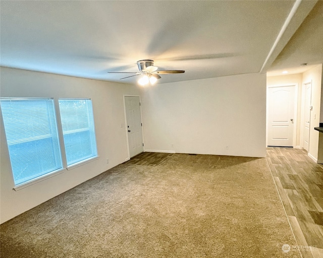 unfurnished room with light wood-type flooring and ceiling fan