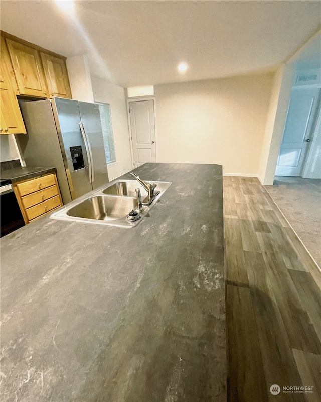 kitchen featuring light brown cabinets, hardwood / wood-style flooring, sink, electric range, and stainless steel fridge with ice dispenser