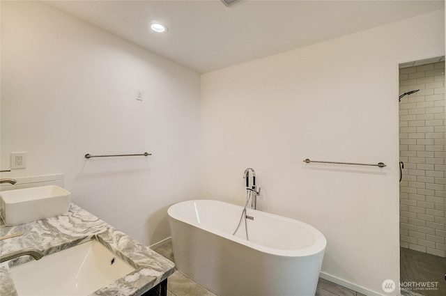 1823 Sam Benn Ln, Aberdeen, WA 98520 - full bathroom with a freestanding bath, double vanity, tiled shower, baseboards, and recessed lighting