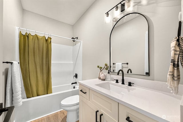 full bathroom with shower / bath combo with shower curtain, hardwood / wood-style floors, toilet, and vanity