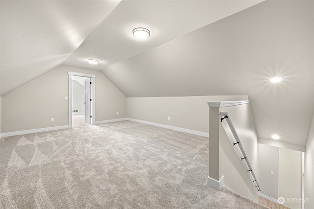 bonus room featuring light carpet and lofted ceiling