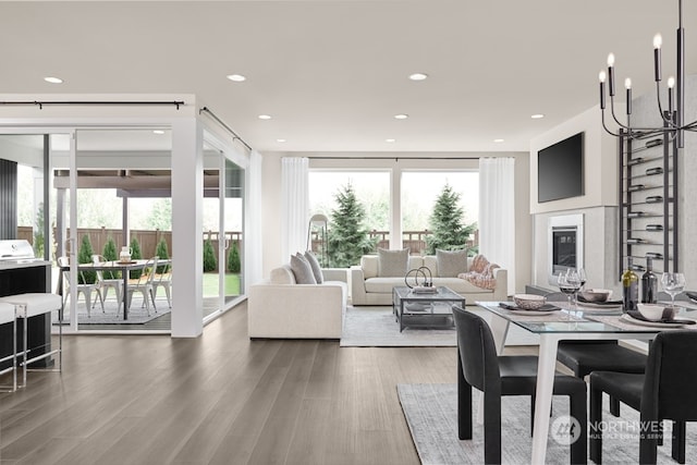 dining room featuring hardwood / wood-style flooring, a wealth of natural light, and an inviting chandelier