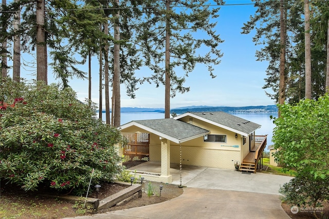 view of front of home featuring a patio and a water view